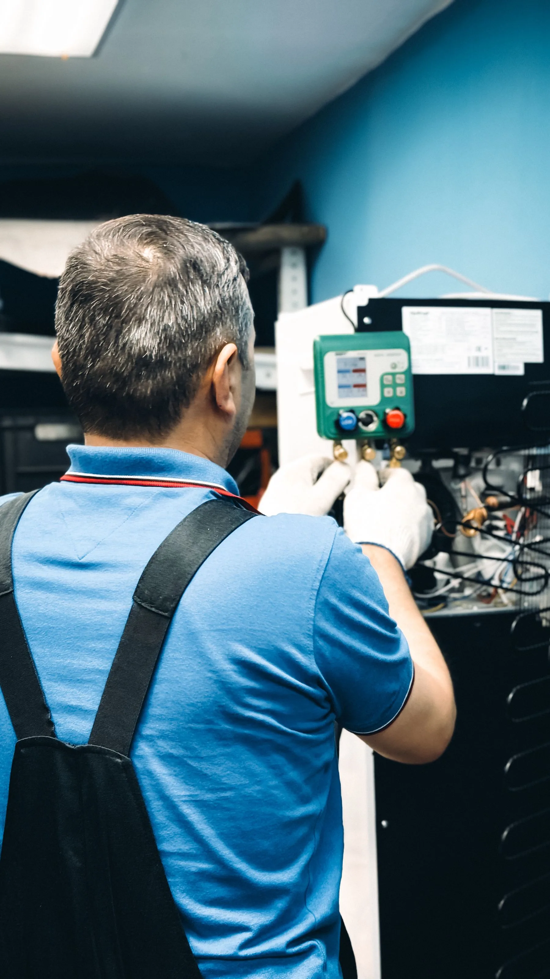 HVAC technician servicing air-conditioning equipment.